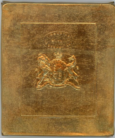 Metal plate. Brass sheet cast with a coat of arms beneath an insignia.