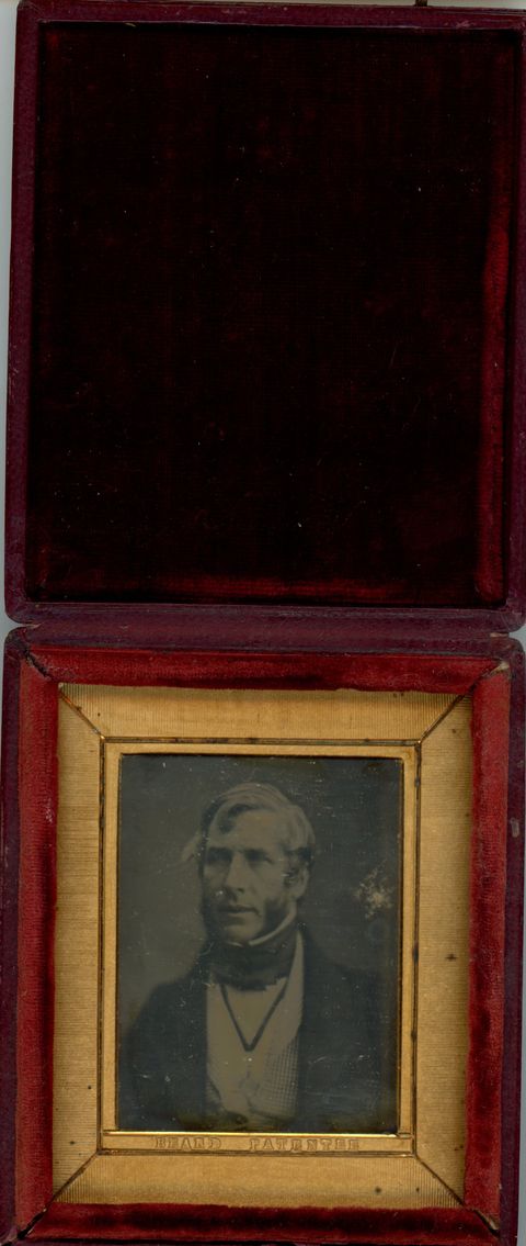 Daguerreotype in an open case. A pale-skinned, light-haired man with thick mutton chops looks off to our left. He is framed in the rectangular opening of a gold mat, which his incised with lines to create a secondary frame. The case flips up, and the cover is lined with dark fabric.
