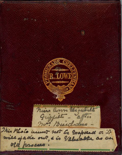 Case. A maroon-red leather case is embossed with a gold insignia. Two labels with handwriting are below. The first has the name of the sitter, and the second reads, “This Photo must not be exposed or it will fade out, and is valuable as an old process”.