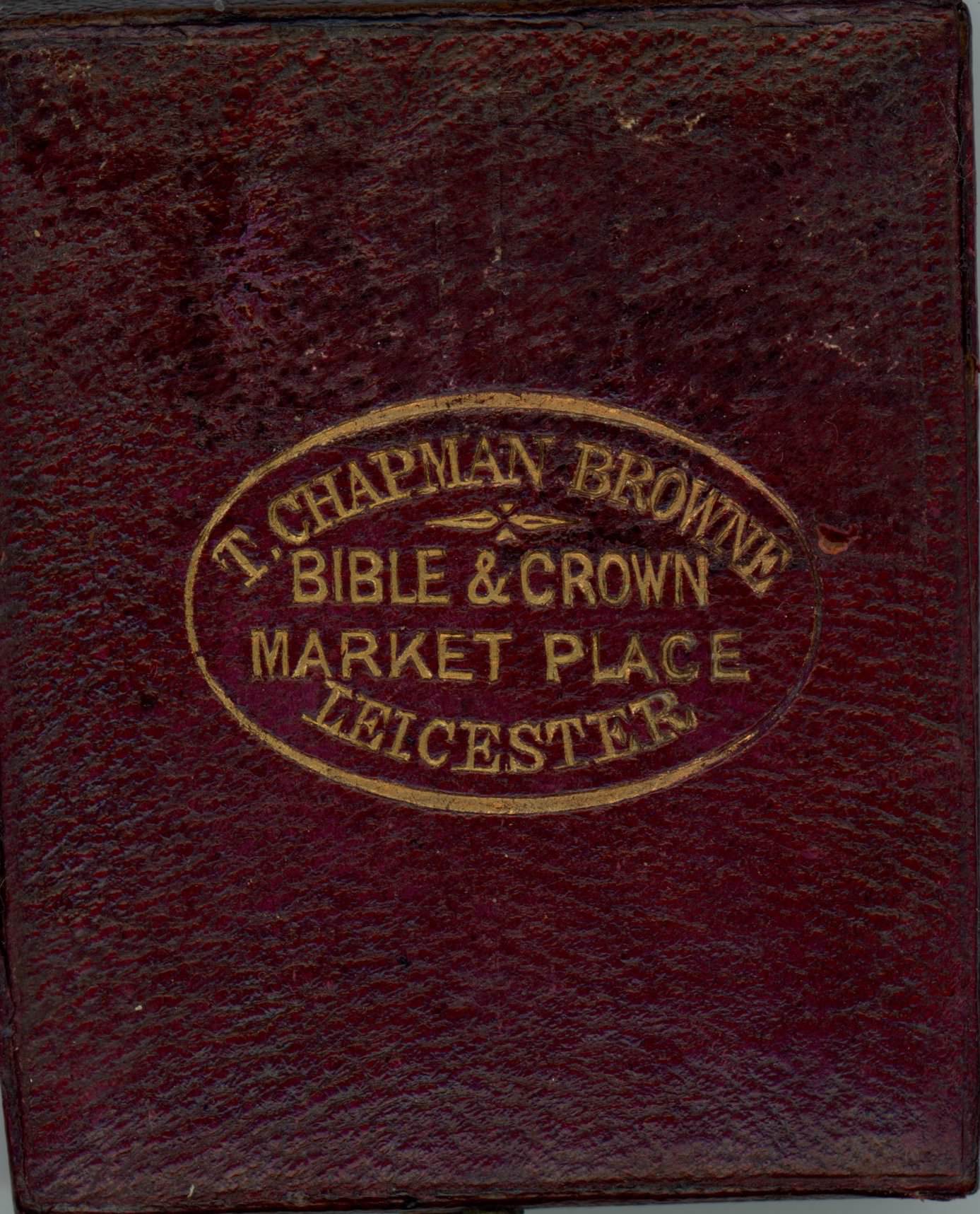 Burgundy-red leather case stamped with a gold insignia.