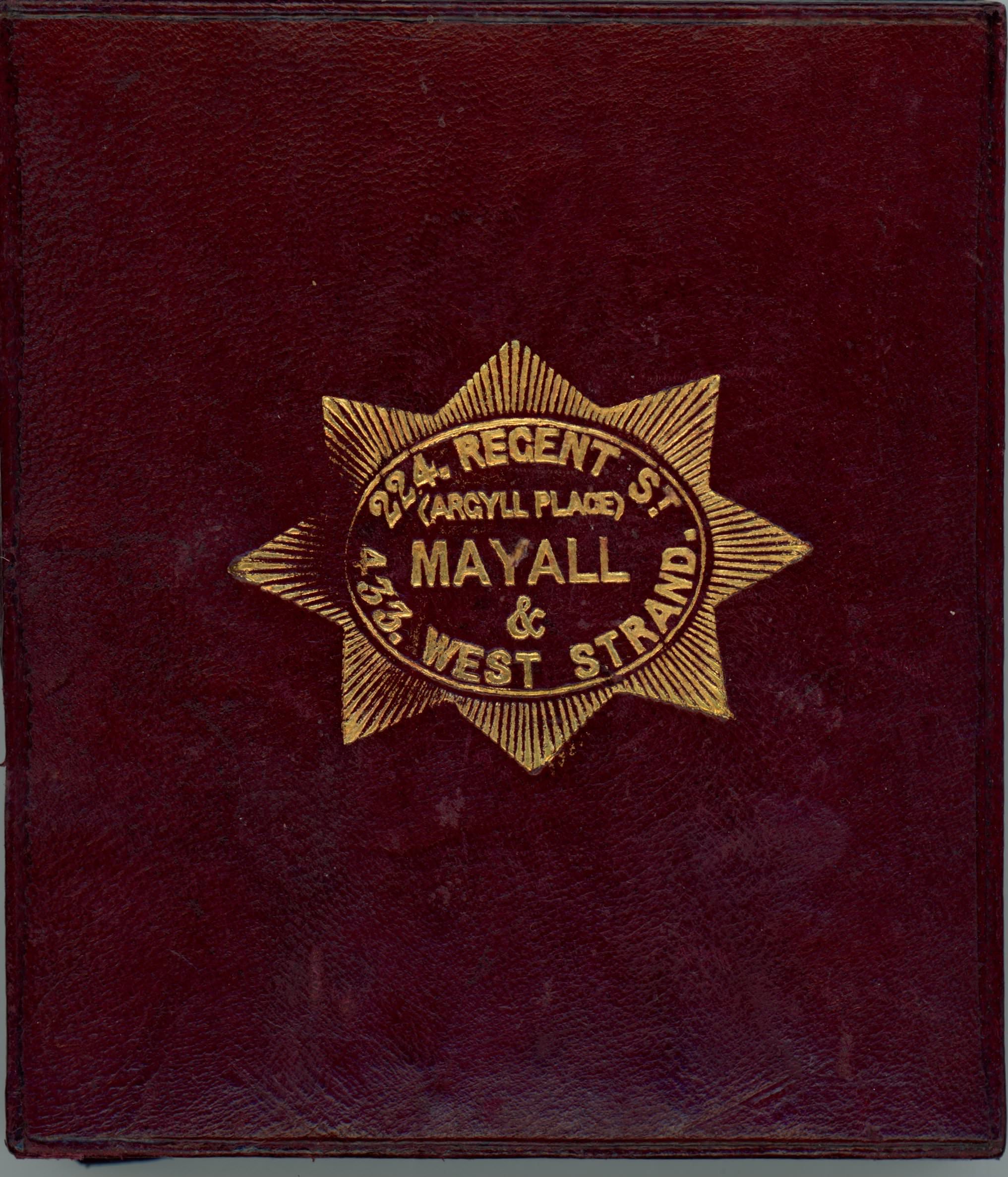 Burgundy-red leather case stamped with a gold insignia. Text within a starburst reads, “224. Regent St (Argyll Place) Mayall & 433. West Strand.”