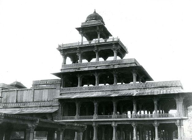 Architecture. This black and white photograph shows a structure made of five levels held up with only pillars, so light and a breeze can pass through. The bottom two levels of the Panch Mahal are the widest, and each subsequent level is narrower, ending with a single square unit at the top.