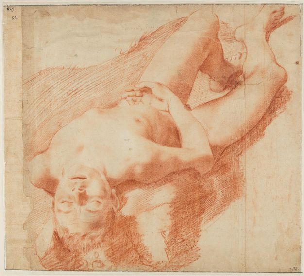 Drawing. With red chalk on cream-coloured paper, a young man is shown lying on his back, his head coming towards us. His head falls back as over a ledge or pillow, so we look onto his smooth-skinned face.