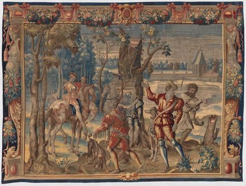 Tapestry. Two men on horseback, four standing on the ground around a broken tree trunk, and two dogs are in a landscape. The scene is framed by woven ornamental strapwork, floral swags, and corbels in the shape of people.