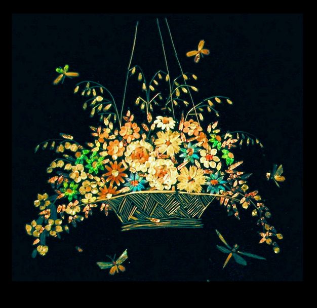 Microphotograph. Taken with the aid of a microscope, an image of a hanging basket of flowers surrounded by five butterflies and dragonflies is made of the iridescent scales of butterflies.
