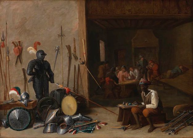 Painting. In a shallow space, pieces of armour and weapons are piled to our left. To our right, a dark-skinned man sits on a wooden box and looks out at us as he cleans a pistol. The room opens beyond the man, on the right half of the painting. There a group of seven pale-skinned men sit and stand around a table, and a seventh lies on an angled board leaning against one wall.