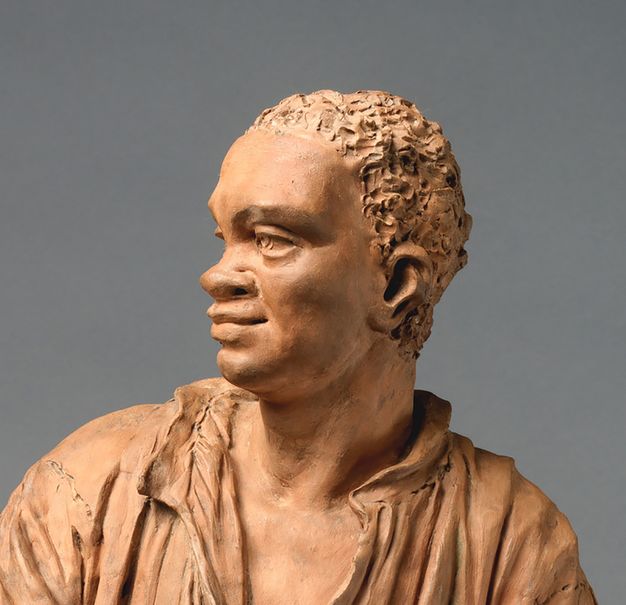 Sculpture. Detail view of the head of a man sculpted with terracotta. The texture of his hair was created with a tool that dug into the wet clay. The man looks to our left in this view. He has a prominent brow, and his wide nose is slightly upturned.