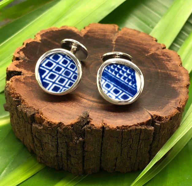Jewellery. Two round fragments of white porcelain painted with deep blue geometric designs have been made into silver-edged cufflinks.
