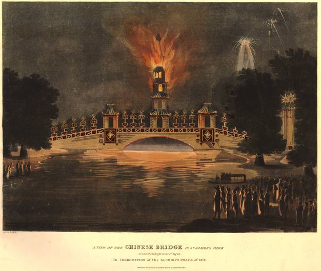 Print. This coloured print shows the top two levels of a four-storey structure on a bridge alight with flame. Fireworks flare in the sky to our right. Spectators on the riverbanks close to us are backlit with an orange glow from the fire.