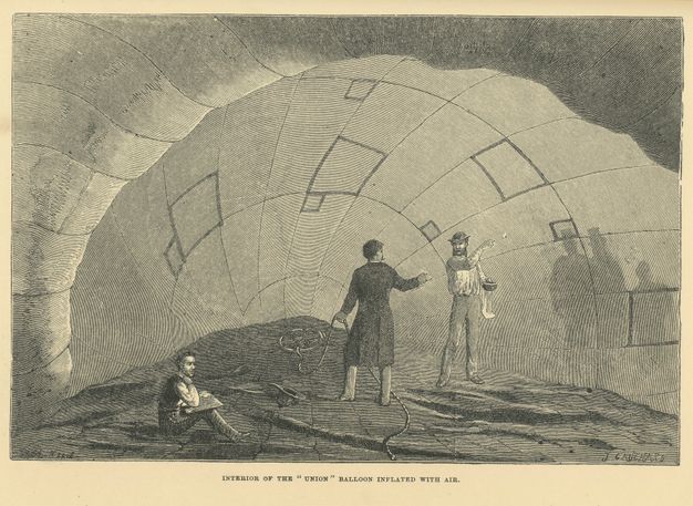 Print. Two men stand and one sit inside a half-inflated balloon. The shadowy silhouettes of people waiting outside are cast on the side of the balloon to our right.