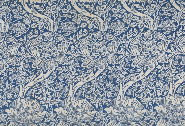 Textile. In a flat, aquamarine blue, stylized roses, thistles, and leaves create a sinuous pattern.