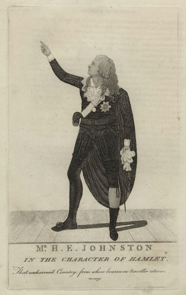 Print. A pale-skinned man with loose curls stands on a stage and holds up one hand. He wears a cape over a black suit. Text below reads, “Mr H. E. Johnston in the Character of Hamlet”.