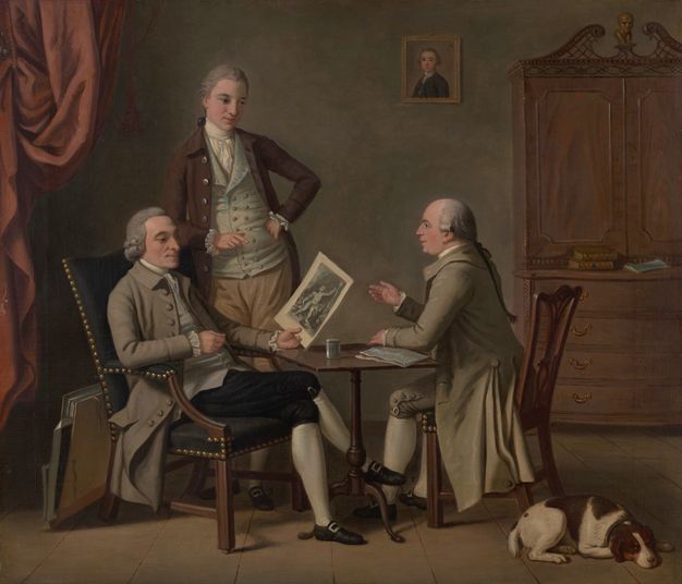 Painting. Three pale-skinned, clean-shaven men sit or stand around a small square table. One seated man holds and looks at a print as the other seated man speaks, one hand lifted.