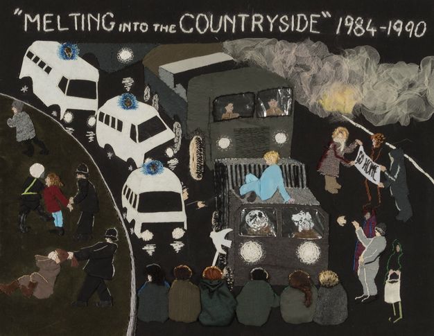 Textile. In a simplified style with blocks of colour, three white emergency vehicles with blue sirens and two armoured vehicles are stopped by a row of six people sitting in the road. Women are handcuffed or pulled by their hair by police to our left. Three people to our right hold up a sign reading 'Go home'.