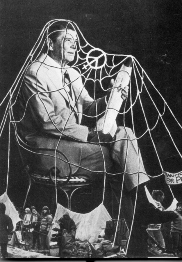 Photomontage. A spider web drapes over a man, Ronald Reagan, sitting with his legs crossed. He holds a missile in one hand. Out of scale, people stand near a tent and hold up protest signs around his feet.