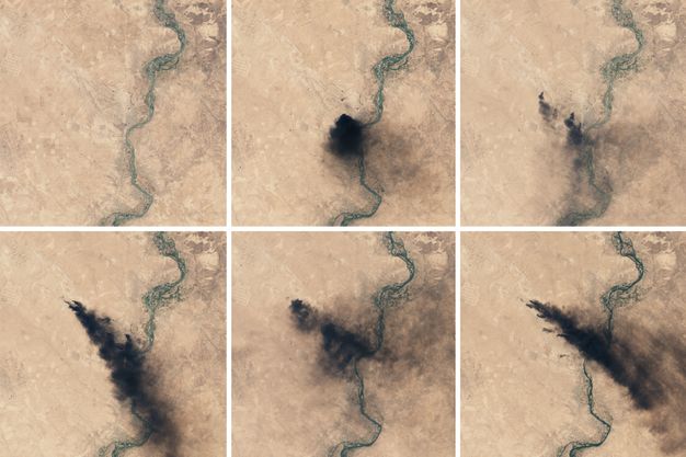 Over the course of six aerial views, a black cloud appears, fades, and then burns into slash of smoke against sand-coloured ground.
