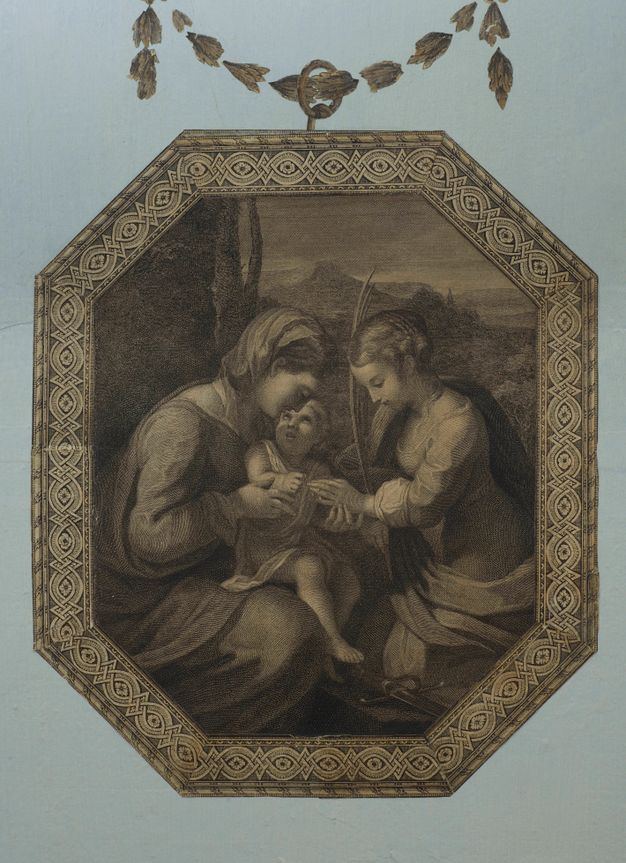 Print. In a hexagonal frame, two women and a baby are close to us against a deep landscape. One woman, Mary, holds the baby Jesus, who looks up at her. The second woman kneels behind a sword and holds a palm frond. Mary touches the hand she holds out to Jesus.
