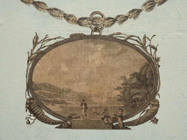 Print. An oval-framed print shows a deep landscape. Three people seem to stand on and in front of a ledge at the bottom centre of the frame, on which the title is written.