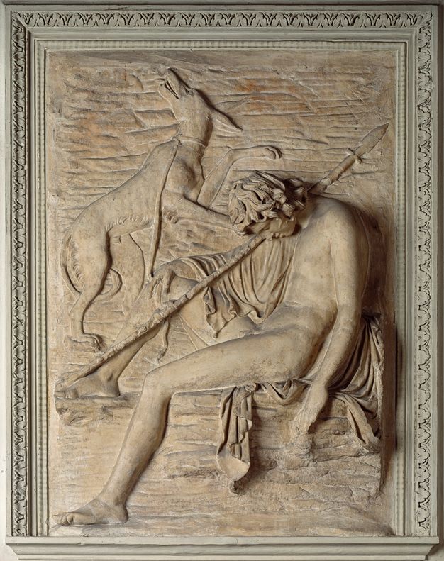 Sculpture. Carved in low relief, a mostly nude young man sits with this head dropped forwards in sleep. One foot is propped up, and a spear rests against that knee and over the shoulder. A dog above the boy turns and looks up, its tail between its legs. One paw appears to be on the boy’s shoulder, and the other is lifted.