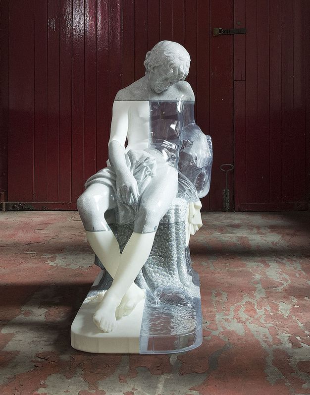 Sculpture. The form of a seated boy with his head dropped forwards in sleep is made in sections of clear, white, or grey resin.
