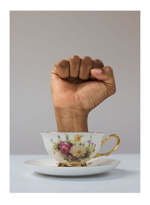 A fourth iteration in the series, where the hand is fully clenched into a fist, emerging from the teacup.