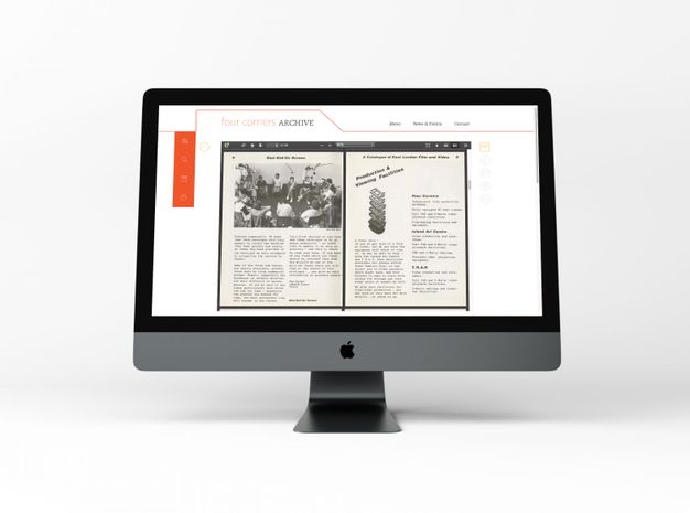 A person's hand using a laptop touchpad, with the laptop screen displaying a digital document titled "The World of Photography or Photography of the World?" The document includes text and black-and-white images. The laptop is placed on a light gray surface.