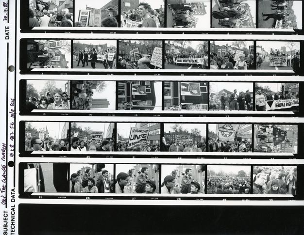 Black and white photograph. Series of 30 photographs on a contact sheet. Protestors and police at the 1988 Stop the Clause March. Groups of people hold banners with text in capitalised letters, including "EQUAL RIGHTS FOR ALL".