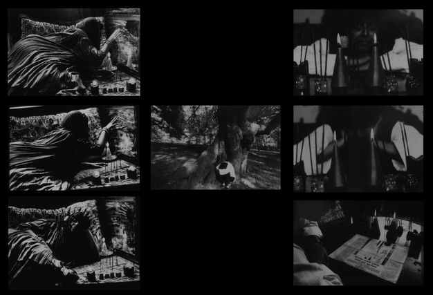 Black and white photographs. Seven photographs in dark frames, with three in a column on the left-hand side showing a woman reclining on a settee with lit candles. One central photograph shows a person beside an established tree. The right column shows a woman, candles and a newspaper.