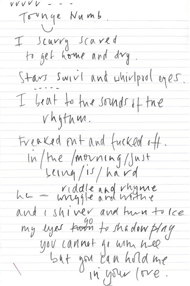 Colour film still. White notepaper with pale red printed lines and handwritten notes in black ink across the page. Writing slopes slightly towards the right and covers most of the page, a diagonal red ink line echoes the flow of writing in the lower-left corner.