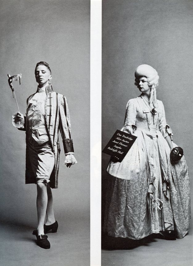 Two black and white photographs. Man with slicked back hair dressed in French aristocratic pantaloons, brocade waistcoat and long striped open jacket, turning his left brogue outward while holding a traditional mask. Woman in voluminous, patterned French dress holding a board with names in cursive text, holding a black Venetian mask.