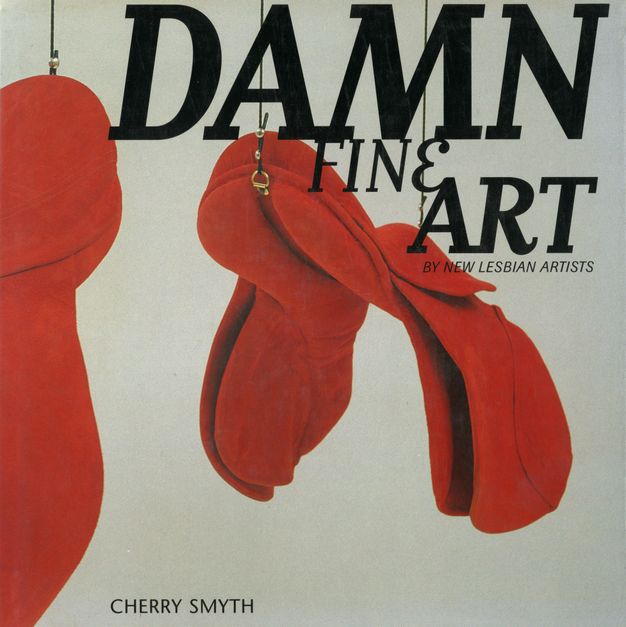 Magazine cover. The words \"Damn Fine Art by Lesbian Artists\" is overlaid across a photograph of hanging sculptures. The two forms are soft red forms and are suspended by leather rope with brass fittings.