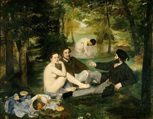 Painting. Two smartly dressed men are seated within a shaded forest. Alongside them a nude woman sits side on, with head turned to look our way, while a basket of food spills out beside her. Her bent arm and leg partially cover her body. In the distance another woman in a thin, strappy slip dress stands in a lake, bending forward to wash herself.