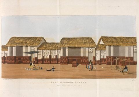 Drawing. We see a row of buildings lining a street, each featuring a thatched, straw roof and an open-plan structure. A series of people carry out activities on the street in front of the buildings; one weaves on a loom, another stands in richly-decorated clothing, and another sits below a sun shade with a picnic laid out, with two children playing nearby. In the lower centre reads the text, ‘Part of Adoom Street.’
