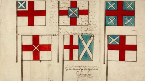 Drawing. A colourful drawing on white paper showing a series of six, hand-drawn flags, each featuring differing combinations of the white on blue saltire ross of the Scottish flag, and the red on white English flag. A small passage of text is positioned in the centre front. 