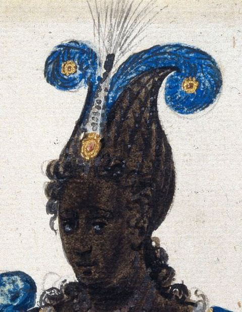 Drawing. A close-up detail of a drawing. This cropped view shows a black woman’s left hand and lower arm lightly raised over a blue and gold patterned dress. She wears a beaded bracelet on her wrist.