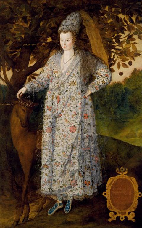 Painting. A colourful, full-length portrait of a woman wearing a long, loosely-fitted floral dress, and a tall headdress with a long sash. She stands within a landscape painted in rustic tones. A deer stands to her right side, and a tree reaches out across the sky in the background.