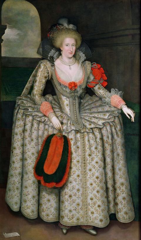Painting. A full-length portrait of a woman dressed in an elaborate, silver patterned dress with gold embroidery, a corset waist and a stiff, full skirt. She carries a red plume feather fan in one hand matched by a red sash tied around her left arm. An arched, open window is just visible behind her.