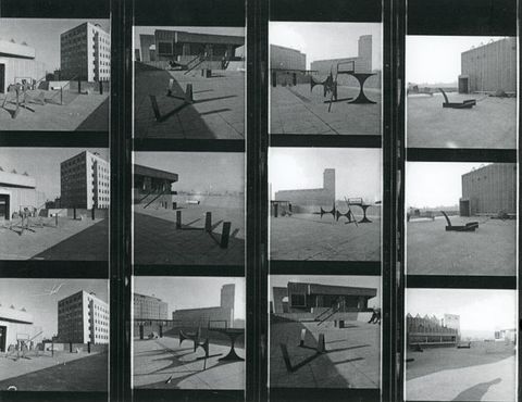 Black and white photograph. A 4 x 3 grid arrangement of black and white photographs documenting metal sculptures situated in outdoor spaces, with various buildings and architectural features around them.