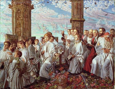 Painting. A group of choir boys seen from a slight side-on angle are dressed in long white gowns and fill much of the scene. To the right a seated crowd of adult men dressed in white or red gowns sit, some holding paper booklets. A carpet of flowers is scattered across the ground, while wide stone pillars in the distance frame the blue, cloud-streaked sky beyond.
